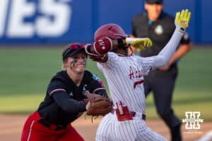 Nebraska Cornhusker starting pitcher/relief pitcher Jordy Frahm (98) tags out Alabama Crimson Tide outfielder Kristen White (3) in the sixth inning during the WCWS second round on Saturday, May 30, 2026, in Oklahoma City. Photo by John S. Peterson.