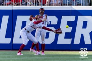 Alabama Crimson Tide outfielders Audrey Vandagriff (12) and Kristen White (3) drop the ball hit by Nebraska Cornhusker Jesse Farrell (25) for a double in the fifth inning during the WCWS second round on Saturday, May 30, 2026, in Oklahoma City. Photo by John S. Peterson.