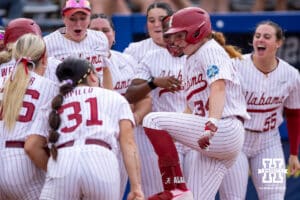 Alabama Crimson Tide catcher Marlie Giles (34) stomps on home plate after hitting a home run in the first inning against the Nebraska Cornhuskers during the WCWS second round on Saturday, May 30, 2026, in Oklahoma City. Photo by John S. Peterson.