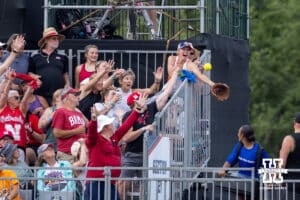 WCWS fan reaches for a home run ball by Alabama Crimson Tide Marlie Giles (34) in the firt inning against the Nebraska Cornhuskers during the WCWS second round on Saturday, May 30, 2026, in Oklahoma City. Photo by John S. Peterson.