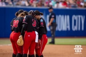 Nebraska Cornhuskers huddle up before the start of the game against the Alabama Crimson Tide during the WCWS second round on Saturday, May 30, 2026, in Oklahoma City. Photo by John S. Peterson.