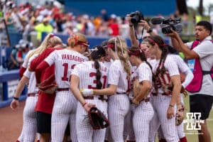 Alabama Crimson Tide huddle up before taking on the Nebraska Cornhuskers during the WCWS second round on Saturday, May 30, 2026, in Oklahoma City. Photo by John S. Peterson.