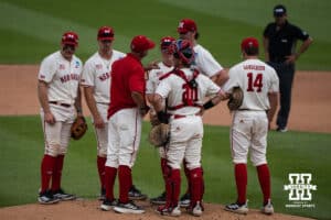 Nebraska Cornhuskers meet on the mound during a regional baseball game against SDSU on May 29, 2026, in Lincoln, Nebraska. Photo by Brandon Tiedemann.