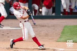 Nebraska Cornhusker Dylan Carey (15) hits during a regional baseball game against SDSU on May 29, 2026, in Lincoln, Nebraska. Photo by Brandon Tiedemann.