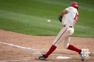 Nebraska Cornhusker Dylan Carey (15) hits the ball during a regional baseball game against SDSU on May 29, 2026, in Lincoln, Nebraska. Photo by Brandon Tiedemann.