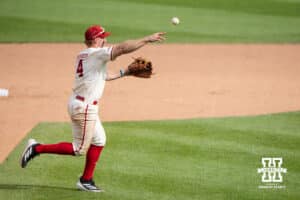 Nebraska Cornhusker Joshua Overbeek (4) throws to first base during a regional baseball game against SDSU on May 29, 2026, in Lincoln, Nebraska. Photo by Brandon Tiedemann.