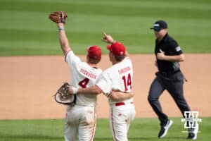 Nebraska Cornhuskers Joshua Overbeek (4) and Case Sanderson (14) celebrate after a regional baseball game against SDSU on May 29, 2026, in Lincoln, Nebraska. Photo by Brandon Tiedemann.