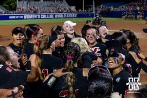 Nebraska Cornhuskers huddle up after the win over the Arkansas Razorbacks in the first day of the WCWS on Thursday, May 28, 2026, in Oklahoma City. Photo by John S. Peterson.