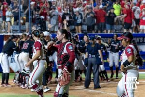 Arkansas Razorbacks wakl off the field while the Nebraska Cornhuskers celebrates the walk-off win during the first round of the WCWS on Thursday, May 28, 2026, in Oklahoma City. Photo by John S. Peterson.