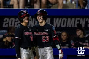 Nebraska Cornhusker Jordy Frahm (98) and Hannah Coor (23) talk to each other at a break in the action against the Arkansas Razorbacks in the 10th inning during the WCWS first round on Thursday, May 28, 2026, in Oklahoma City. Photo by John S. Peterson.