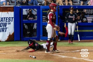 Nebraska Cornhusker Kennadi Williams (15)slides at home for a run against the Arkansas Razorbacks in the fourth inning during the WCWS first round on Thursday, May 28, 2026, in Oklahoma City. Photo by John S. Peterson.