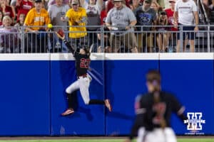 Nebraska Cornhusker outfielder Hannah Coor (23) reaches for the home run ball by Arkansas Razorback utility Kailey Wyckoff (46) in the second inning during the WCWS first round on Thursday, May 28, 2026, in Oklahoma City. Photo by John S. Peterson.