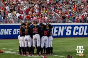 A group of Nebraska Cornhuskers huddle up before the game against the Arkansas Razorbacks during the WCWS first round on Thursday, May 28, 2026, in Oklahoma City. Photo by John S. Peterson.