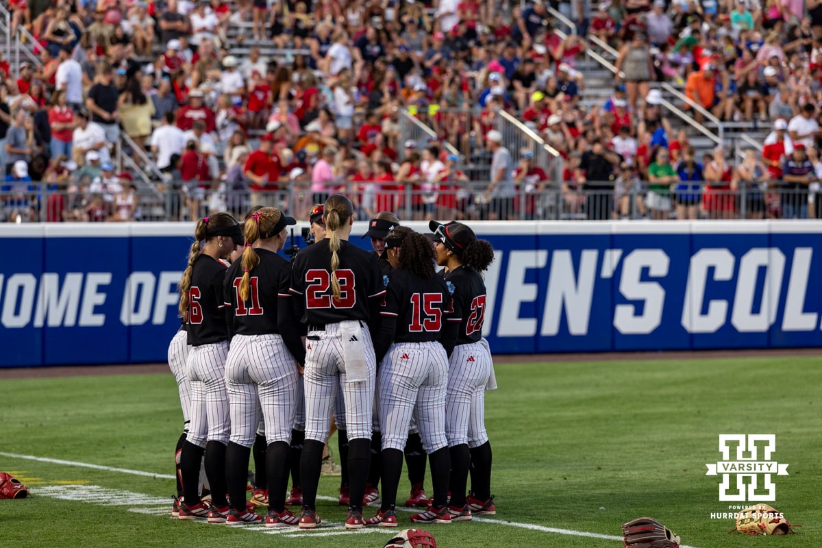A group of Nebraska Cornhuskers huddle up before the game against the Arkansas Razorbacks during the WCWS first round on Thursday, May 28, 2026, in Oklahoma City. Photo by John S. Peterson.