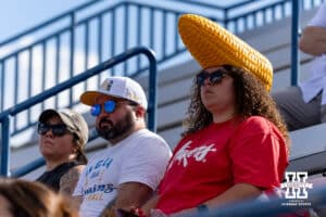 Nebraska Cornhuskers fan and a UCLA Bruins fan watching warm ups for the UCLA game before the Huskers take on the Arkansas Razorbacks during the WCWS first round on Thursday, May 28, 2026, in Oklahoma City. Photo by John S. Peterson.