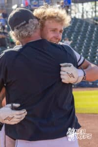 Skutt Catholic's coach Damon Day hugging his son Bubba Day (17) after winning a Nebraska baseball Class B state championship game against Elkhorn North on Saturday, May 23, 2026, in Omaha, Neb. Photo by Jandi Green.