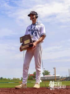 Lincoln Lutheran’s Braxton Glines (9) holding the championship trophy in an interview after winning a Nebraska baseball Class C state championship game against Mount Michael Benedictine on Saturday, May 23, 2026, in Omaha, Neb. Photo by Jandi Green.