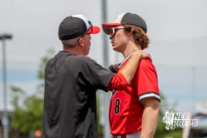 Mount Michael’s Camden Cerone (8) talking to the coach during a Nebraska baseball Class C state championship game against Lincoln Lutheran on Saturday, May 23, 2026, in Omaha, Neb. Photo by Jandi Green.