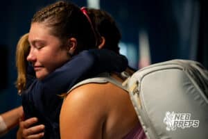 An Omaha Marian tennis player embraces with one of her coaches after losing in the state title game during a state tennis tournament, Friday, May. 22, 2026, Lincoln, Nebraska. Photo by Braden Cochran.