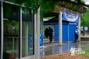 Lincoln East head coach Christopher Stock stands outside of Woods tennis center with rain coming down during a state tennis tournament, Friday, May. 22, 2026, Lincoln, Nebraska. Photo by Braden Cochran.