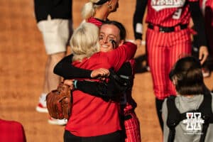 Nebraska Cornhusker Jordy Frahm (98) embraces head coach Rhonda Revelle after the Huskers defeat the Oklahoma State Cowgirls in game two to end the series during the NCAA Softball Super Regionals at Rhonda Revelle Field at Bowlin Stadium on Saturday, May 23, 2026 in Lincoln, Neb. Photo by Collin Stilen.