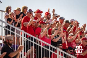 Nebraska Cornhusker fans celebrate a homerun during the NCAA Softball Super Regionals at Rhonda Revelle Field at Bowlin Stadium on Saturday, May 23, 2026 in Lincoln, Neb. Photo by Collin Stilen.