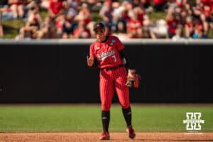 Nebraska Cornhusker Ava Kuszak (7) signifies two outs after her catch during the NCAA Softball Super Regionals at Rhonda Revelle Field at Bowlin Stadium on Saturday, May 23, 2026 in Lincoln, Neb. Photo by Collin Stilen.