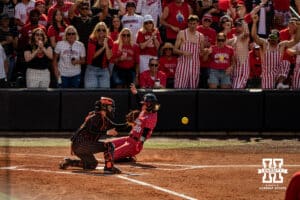 Nebraska Cornhusker fans watch closely as Jordy Frahm (98) slides into home plate during the NCAA Softball Super Regionals at Rhonda Revelle Field at Bowlin Stadium on Saturday, May 23, 2026 in Lincoln, Neb. Photo by Collin Stilen.