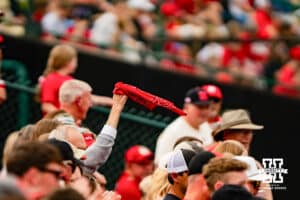 Nebraska Cornhusker fan swings bandana during a softball game at Rhonda Revelle Field at Bowlin Stadium on Friday, May 22, 2026 in Lincoln, Neb. Photo by Collin Stilen.