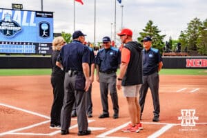 Nebraska Cornhusker head coach, Rhonda Revelle and Oklahoma State head coach, Kenny Gajewski, meet at the plate during a softball game at Rhonda Revelle Field at Bowlin Stadium on Friday, May 22, 2026 in Lincoln, Neb. Photo by Collin Stilen.