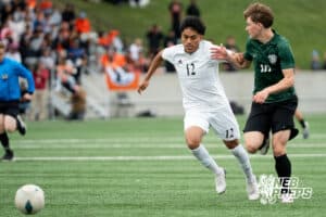 Gretna's Nate Thiellen (10) held by Lexington's Juan Raymundo-Jesus (12) while chasing down the ball during the 2026 Class B Boys State Soccer Championship match Wednesday, May 20, 2026, in Omaha, Nebraska. Photo by Jackson D. Luethje.