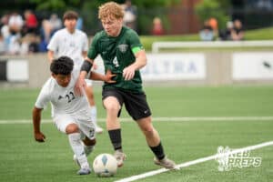 Gretna's Evan Lafferty (4) defnded by Lexington's Miguel Tercero-Pascual (22) during the 2026 Class B Boys State Soccer Championship match Wednesday, May 20, 2026, in Omaha, Nebraska. Photo by Jackson D. Luethje.