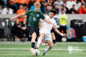Gretna's Sawyer Hehn (11) defended by Lexington's David Gomez-Aquino (8) during the 2026 Class B Boys State Soccer Championship match Wednesday, May 20, 2026, in Omaha, Nebraska. Photo by Jackson D. Luethje.