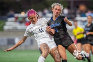 Elkhorn South's Emery Grace (11) defends Omaha Marian's Emmy Boyle (2) during the 2026 Class A Girls State Soccer Championship match Tuesday, May 19, 2026, in Omaha, Nebraska. Photo by Jackson D. Luethje.