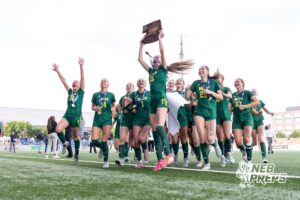 Lincoln Pius X’s Haley Thomsen (15) is raising up the NSAA Class B State Championship trophy while running to the crowd with her team behind her after winning the NSAA Class B Girls State Championship game against Blair on Tuesday, May 19, 2026 in Omaha, Nebraska. Photo By Jack Stephens
