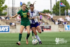 Blair’s Cadence Field (7) is dribbling through contact from Lincoln Pius X’s Brooke Thomsen (22) during the NSAA Class B Girls State Championship game on Tuesday, May 19, 2026 in Omaha, Nebraska. Photo By Jack Stephens