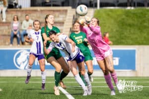 Lincoln Pius X’s Emma Miller (99) is punching the ball of of the way so Blair’s Laynie Brown (2) can’t hit it during the NSAA Class B Girls State Championship game on Tuesday, May 19, 2026 in Omaha, Nebraska. Photo By Jack Stephens