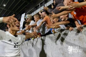 Lexington’s Cesar Munoz (27) is celebrating with the crowd after winning a high school state soccer game against Schuyler on Saturday, May 16, 2026, in Omaha, Nebraska. Photo By Jack Stephens.