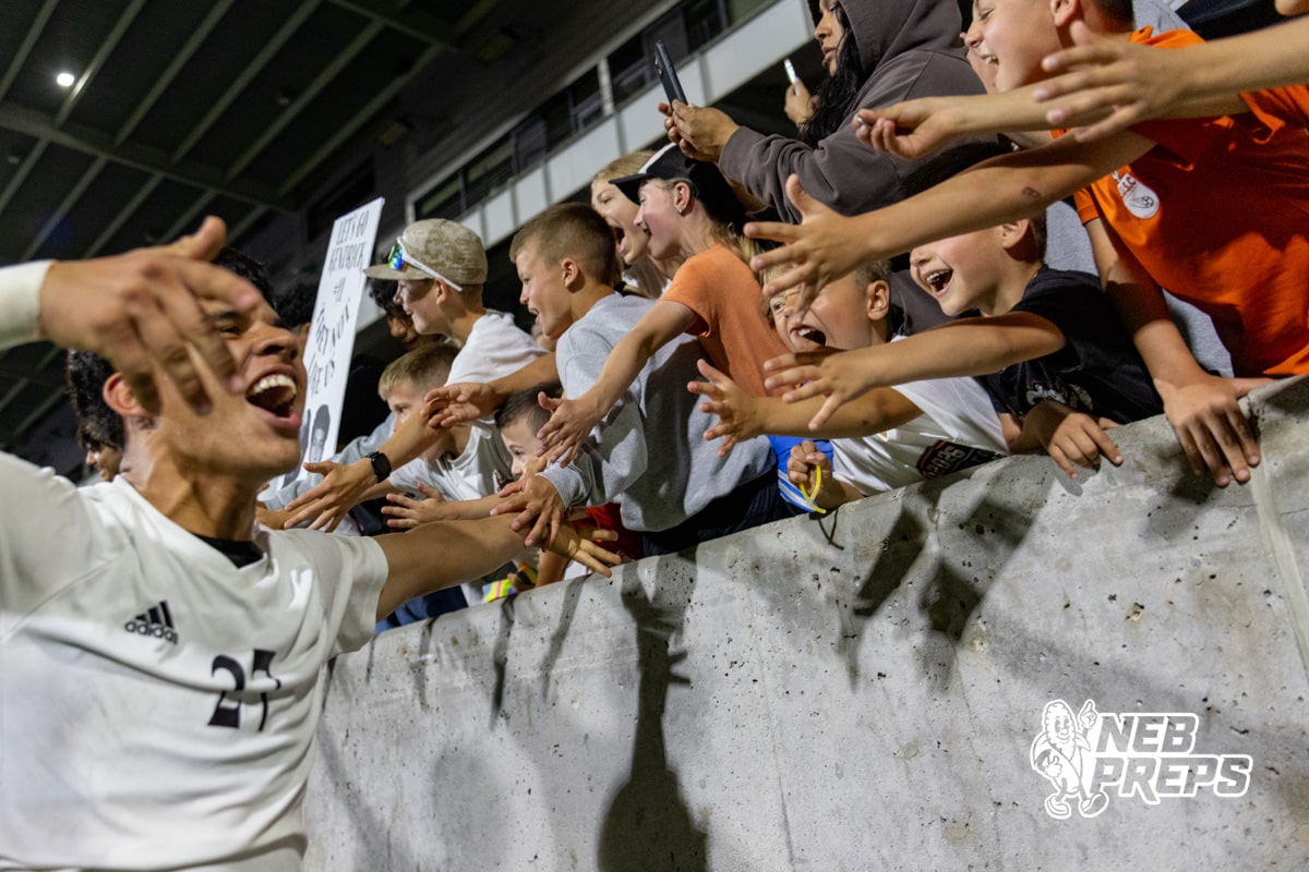 Lexington’s Cesar Munoz (27) is celebrating with the crowd after winning a high school state soccer game against Schuyler on Saturday, May 16, 2026, in Omaha, Nebraska. Photo By Jack Stephens.