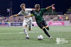 Lexington’s Christopher Muro (41) and Schuyler’s Richard Delgado (22) are fighting for possession of the ball during a high school state soccer game on Saturday, May 16, 2026, in Omaha, Nebraska. Photo By Jack Stephens.