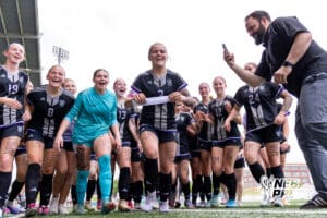 Blair’s Kaitlynn O’Neil (3) is slapping the Bears’ name on the bracket board after winning a high school state soccer game against Skutt Catholic during a NSAA Class B semi-finals soccer match on Saturday, May 16, 2026, in Omaha, Nebraska. Photo By Jack Stephens.