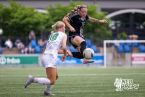 Blair’s Tilde Hall (16) is jumping in the air to kick the ball against Skutt Catholic during a NSAA Class B semi-finals soccer match on Saturday, May 16, 2026, in Omaha, Nebraska. Photo By Jack Stephens.