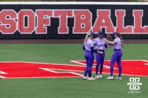 Grand Canyon Antelope outfielders huddle up as their pitcher throws a few warm-up pitches against the Nebraska Cornhuskers during the NCAA Softball Regionals on Sunday, May 17, 2026, in Lincoln, Neb. Photo by John S. Peterson.