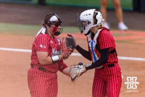 Nebraska Cornhusker starting pitcher Alexis Jensen (99) and catcher Jesse Farrell (25) meet against the Grand Canyon Antelopes during the NCAA Softball Regionals on Sunday, May 17, 2026, in Lincoln, Neb. Photo by John S. Peterson.