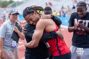 Nebraska Cornhusker James Ledbetter hugs his coach during the Big Ten OTF Championships on May 17, 2026, in Lincoln, Nebraska. Photo by Brandon Tiedemann.