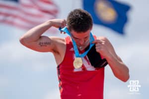 Nebraska Cornhusker Dyson Wicker puts on his medal during the Big Ten OTF Championships on May 17, 2026, in Lincoln, Nebraska. Photo by Brandon Tiedemann.