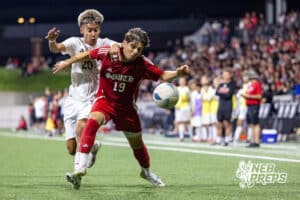 Omaha South’s Erick Perlera (19) is trying to dribble the ball through heavy contact from Omaha Westside’s Sebastian Perez Rojas (20) during semi-finals of the NSAA State Soccer Championships on Friday, May 15, 2026, in Omaha, Nebraska. Photo By Jack Stephens.