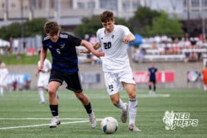 Lincoln Southwest’s Abedin Music (20) is dribbling the ball past Papio South’s Ethan Jeffers (5) during semi-finals of the NSAA State Soccer Championships on Friday, May 15, 2026, in Omaha, Nebraska. Photo By Jack Stephens.