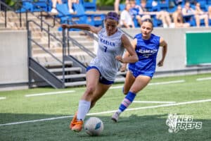 Omaha Marian’s Cleo Washington (7) is dribbling the ball past a defender against Kearny during semi-finals of the NSAA State Soccer Championships on Friday, May 15, 2026, in Omaha, Nebraska. Photo By Jack Stephens.