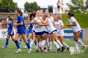 Omaha Marian’s Mya Sennett (17) is celebrating with her teammates after scoring a goal against Kearney during semi-finals of the NSAA State Soccer Championships on Friday, May 15, 2026, in Omaha, Nebraska. Photo By Jack Stephens.